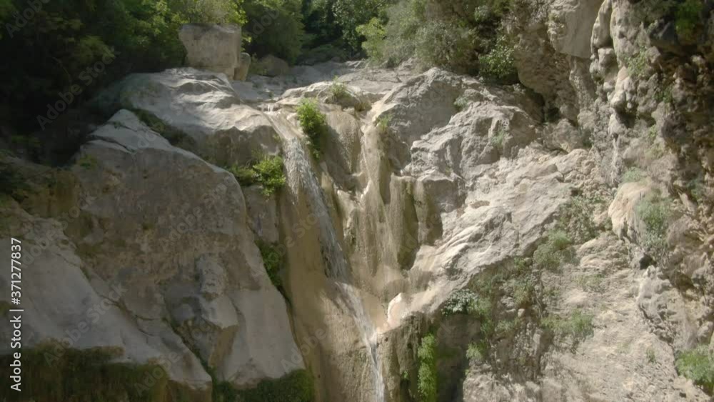 Ascending drone shot of Dimosari Waterfall in Lefkada Ascending drone shot of Dimosari Waterfall in Lefkada