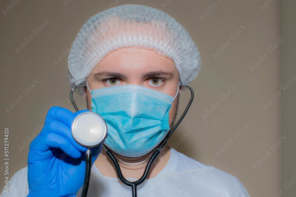 Doctor in medical mask with stethoscope Doctor in medical mask with stethoscope