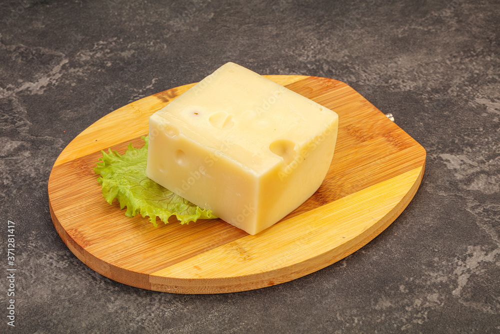 Emmental cheese over wooden board