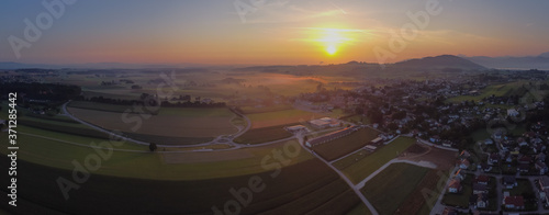Beautiful misty colorful morning view of the village of Sankt Georgen im Attergau, idyllical austrian village in early morning, at sunrise. Epic sunrise in Austria.
