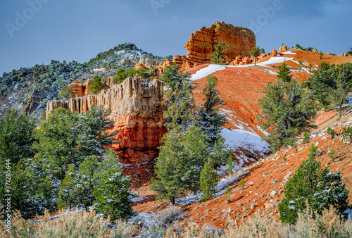 Red rocks with clouds and snow