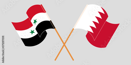 Crossed and waving flags of Syria and Bahrain