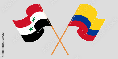 Crossed and waving flags of Syria and Colombia