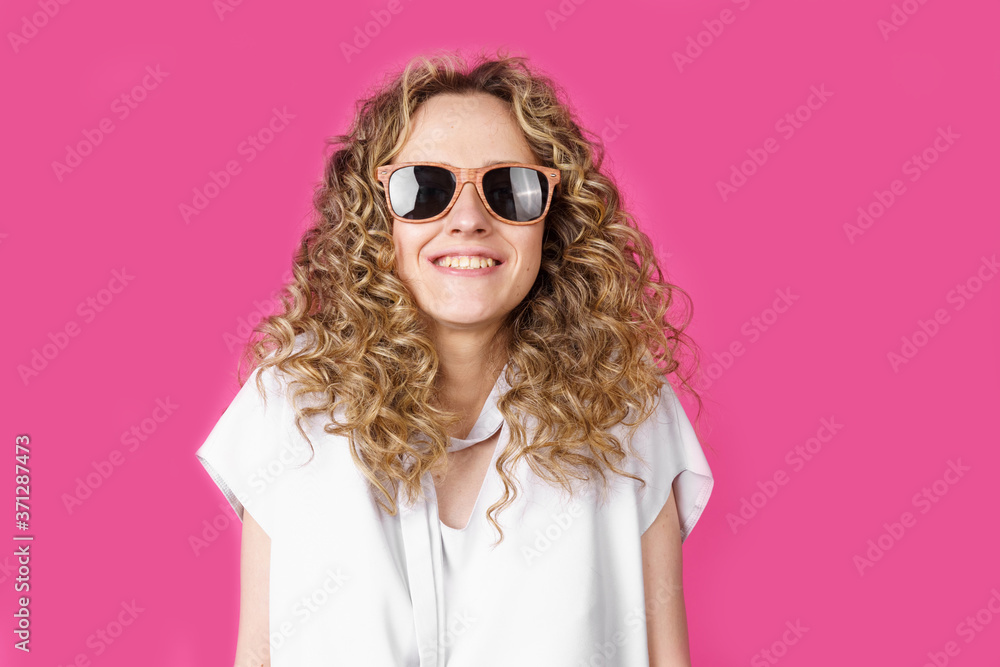Young woman wearing glasses smiling shrugging shoulders. Female portrait.