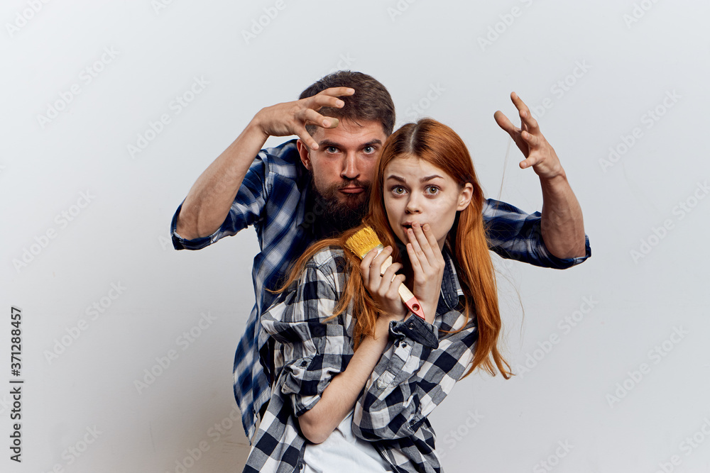 family young couple in plaid shirts repairing construction tools family young couple in plaid shirts repairing construction tools