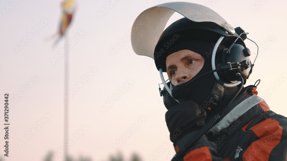 Paramotorgliding. Portrait of a man removing safety helmet after landing. High quality photo Paramotorgliding. Portrait of a man removing safety helmet after landing. High quality photo