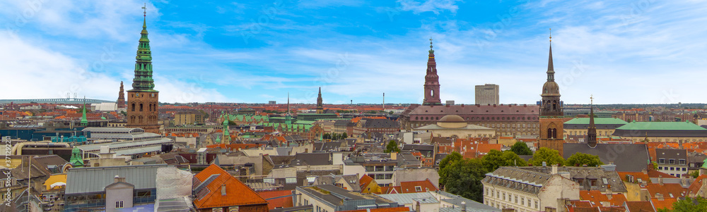 Ancient spires dot the skyline of Copenhagen, Denmark in the summertime