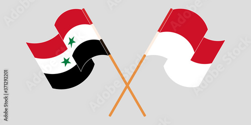 Crossed and waving flags of Syria and Indonesia