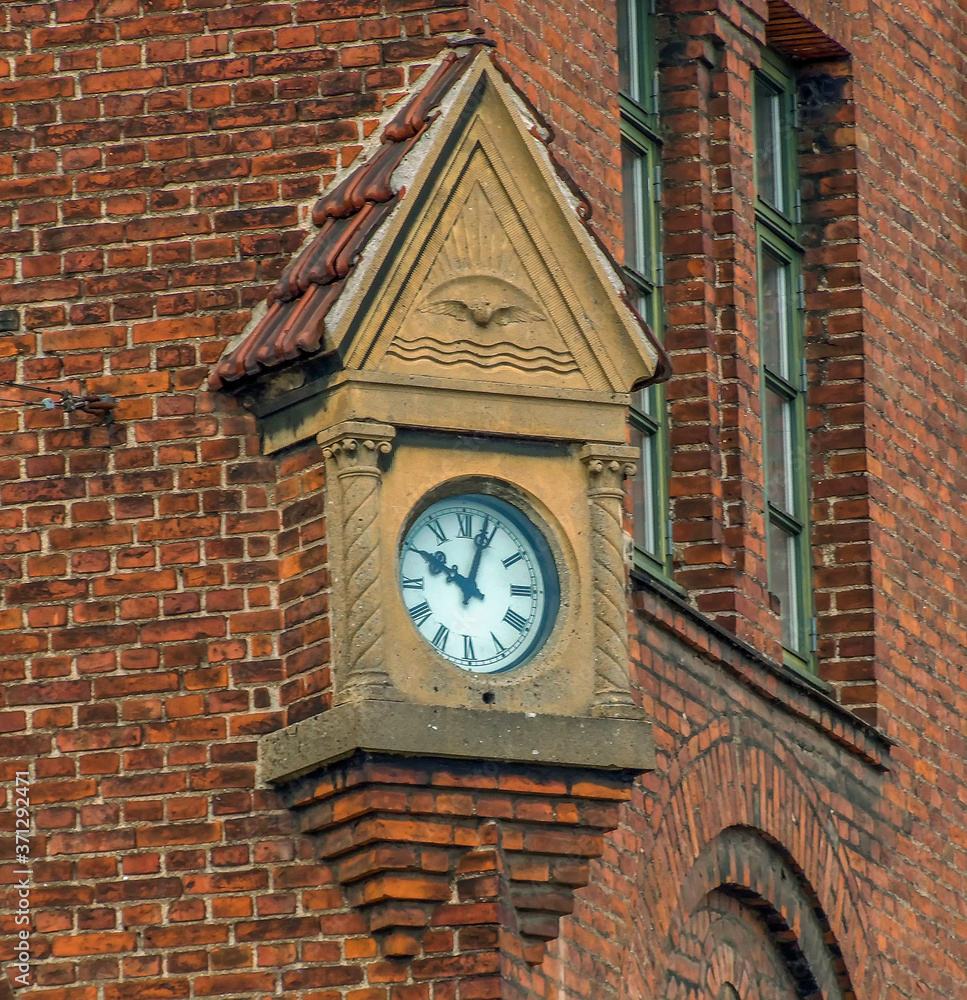 Fototapeta premium A wall clock in the district of Nyhavn in Copenhagen, Denmark in the summertime