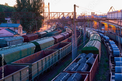 view of the industrial port in the evening - the railway and wagons deliver goods to the ships for transportation by sea