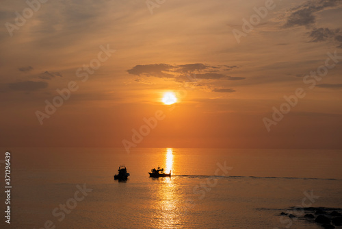 fishing boat at sunset © Ulas Gedikoglu