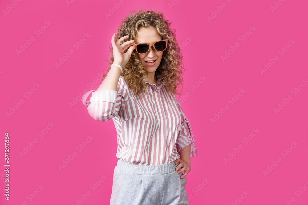 Portrait of a young, beautiful, healthy woman holding glasses and looking at the camera. Portrait of a young, beautiful, healthy woman holding glasses and looking at the camera.