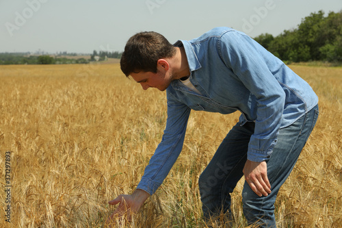 Young man in barley field. Agriculture business. Farming © Atlas