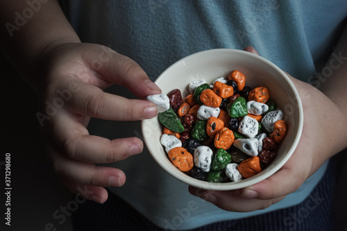 Hand holding a stone candy in a cup