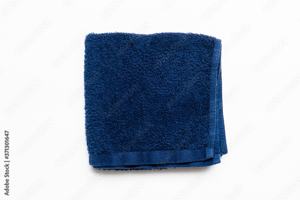 Soft folded tblue towel isolated on white, top view Soft folded tblue towel isolated on white, top view