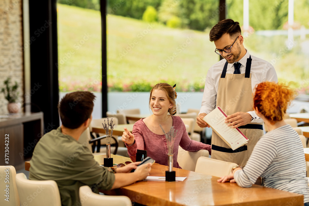Group of happy friends talking while making order in a cafe. Group of happy friends talking while making order in a cafe.