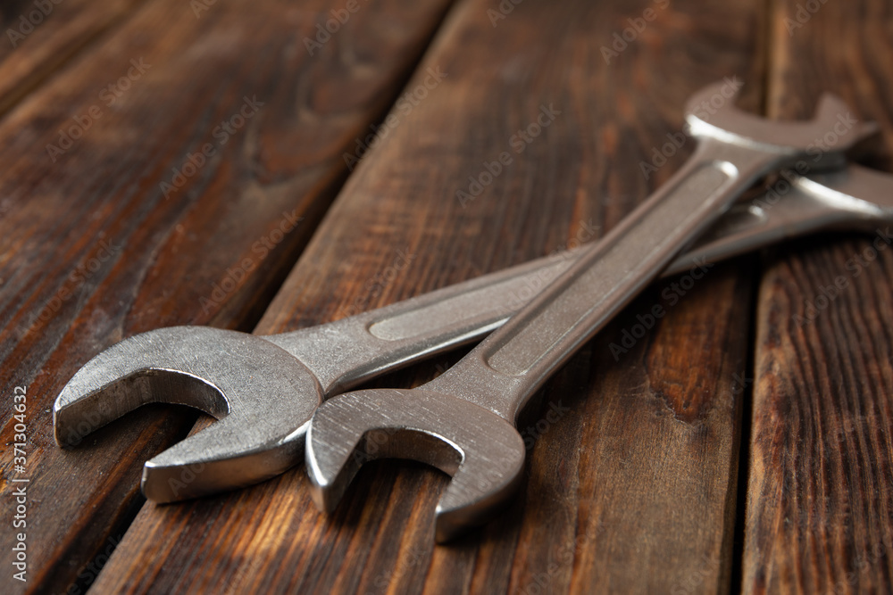 Mechanic wrenches on wooden background, close up Mechanic wrenches on wooden background, close up