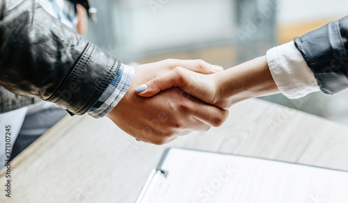 Man and woman hand shaking. Handshake after good cooperation, Businesswoman Shaking hands with Professional businessman after discussing good deal of contract. Business concept.