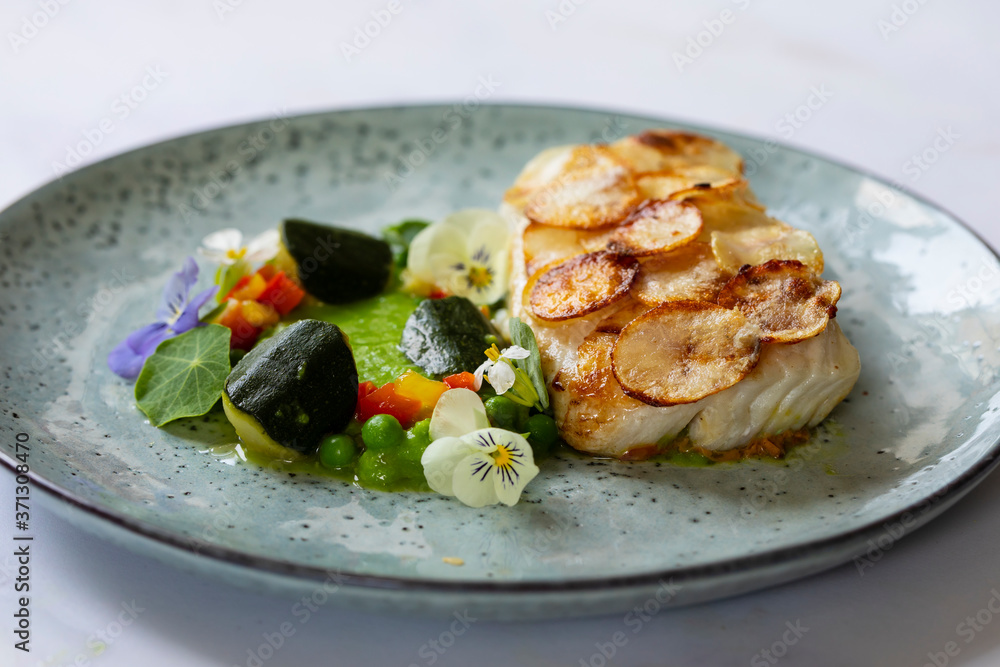 White fish fillet with potato scale, pea puree and summer vegetable White fish fillet with potato scale, pea puree and summer vegetable