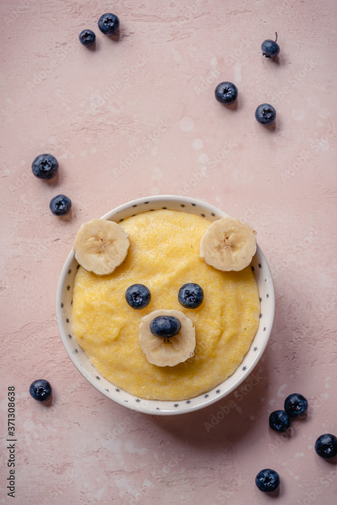 Kids breakfast, porridge with fruits and berries, face bears - obrazy, fototapety, plakaty 