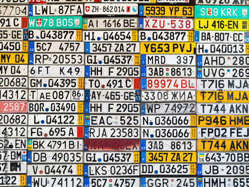 Odessa, Ukraine - circa 2017: License numbers auto from all over world on display. Discontinued license plate of cars from Europe car on old wall. Background of old vintage antique car license plates 