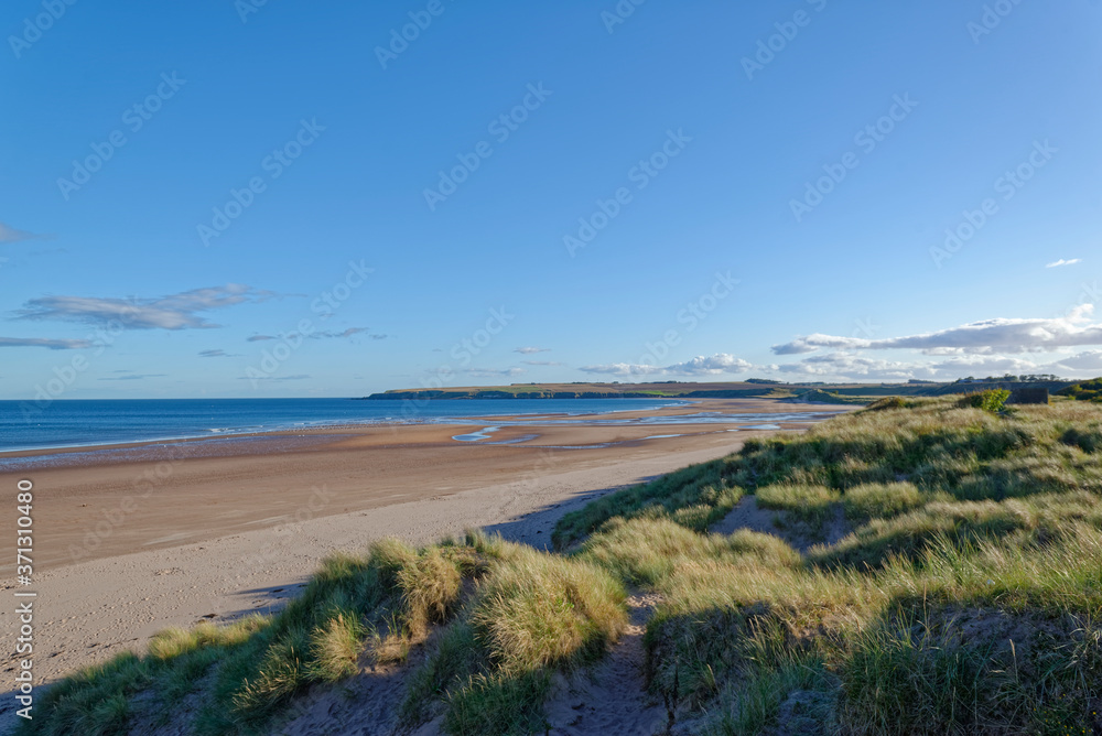 St Cyrus Beach in Aberdeenshire looking South on one Fine Autumn day, with the exposed beach from the low tide stretching away into the Distance. St Cyrus Beach in Aberdeenshire looking South on one Fine Autumn day, with the exposed beach from the low tide stretching away into the Distance.