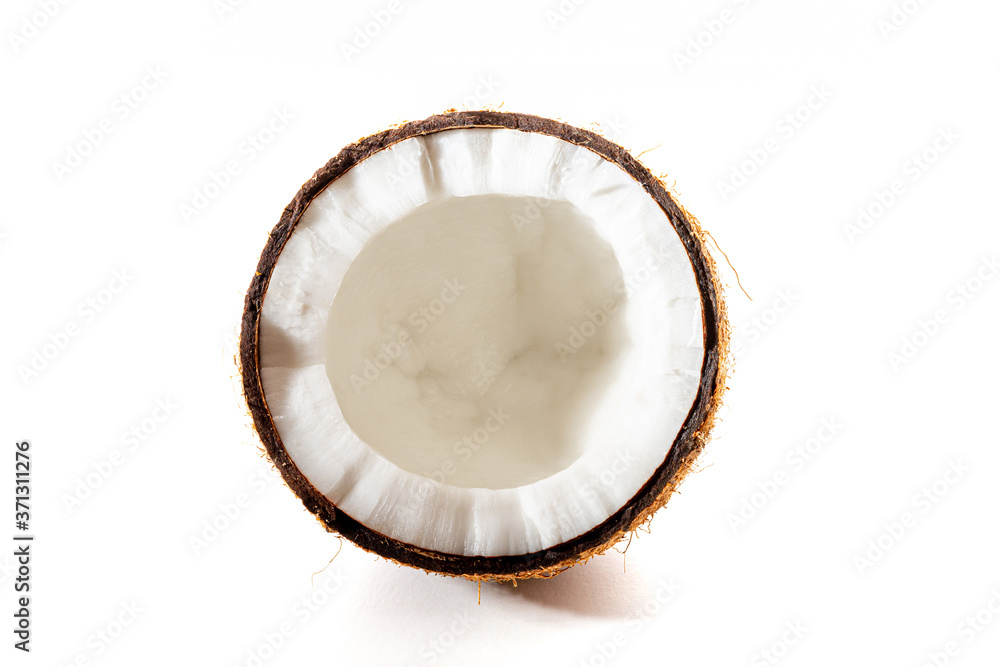 Coconut on a black background. Chopped coconut. Several parts. Stone surface. Fresh coconut. White pulp. Coconut on a black background. Chopped coconut. Several parts. Stone surface. Fresh coconut. White pulp.
