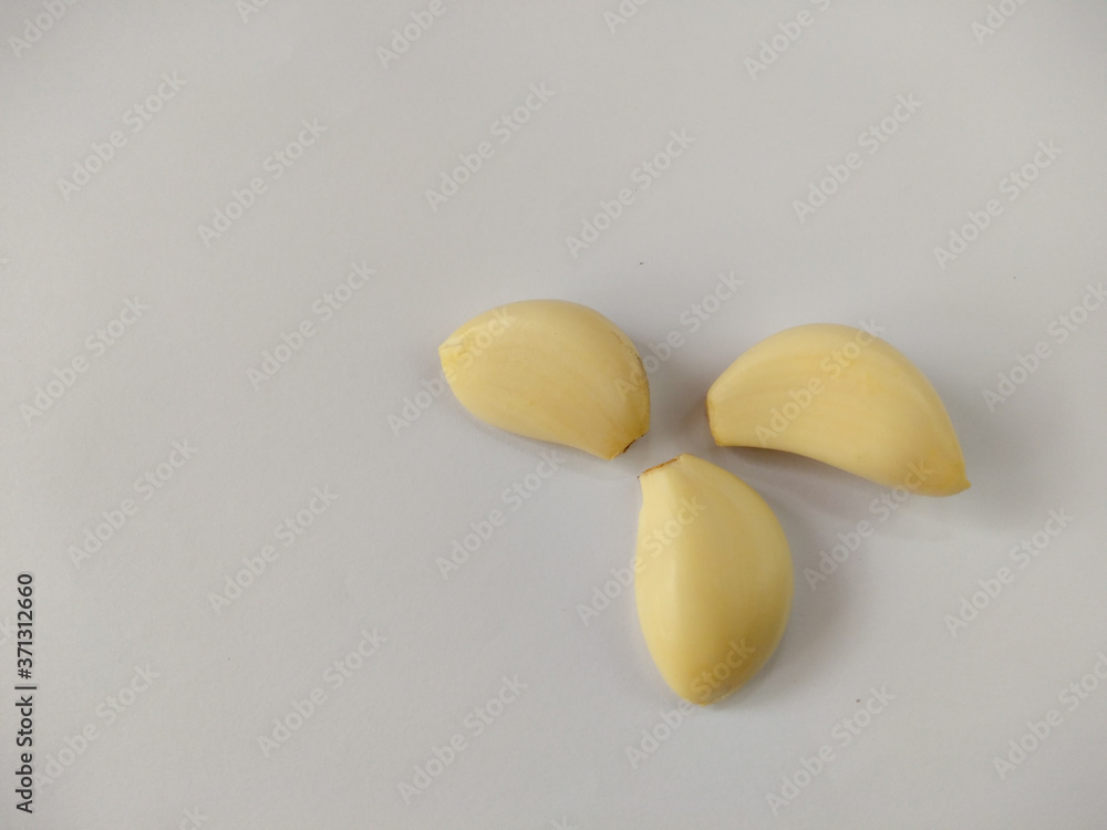 Closeup peeled garlic (Allium sativum) on a white background. garlic as a seasoning for flavoring food