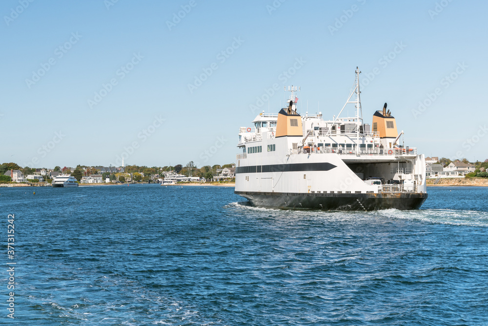 Huge car ferry sailing into a harbour on a clear autumn day