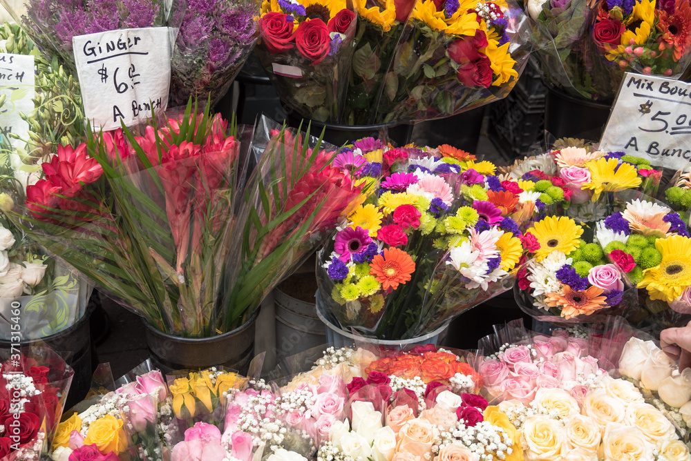 Bunches of multicolour flowers on stalls outside a florist shop