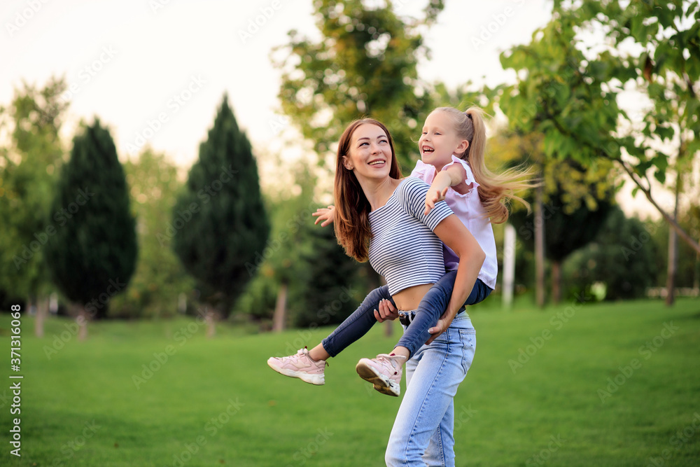 Fototapeta premium Happy family, mother and daughter in nature in the Park