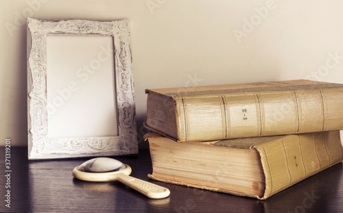 Vintage book and magnifying glass on wooden backgroundas background for art design. Selective focus. photo