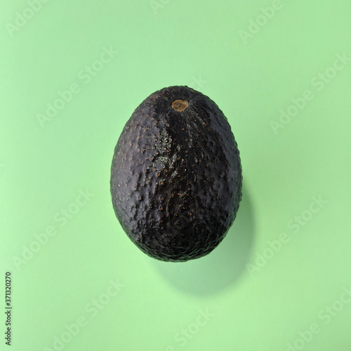 Simple avocado on green background