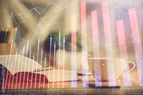 Multi exposure of forex graph drawing and desktop with coffee and items on table background. Concept of financial market trading