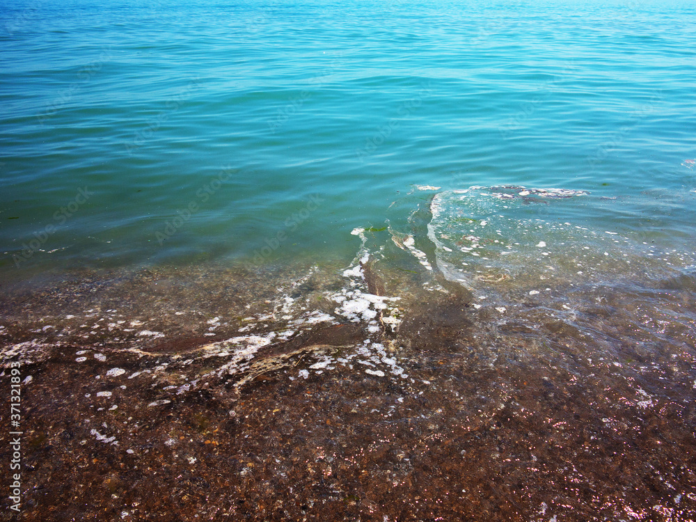 Obraz premium Authentic landscape of polluted sea water. Sewage drains into the river, the sea, the lake. Environmental pollution. Wastewater, ecological catastrophe