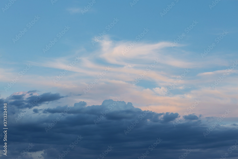 Beautiful atmospheric dramatic clouds in the evening at sunset.
