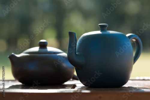 Chinese tea ceremony. Ceramic teapot made of clay and bowls on a wooden background.