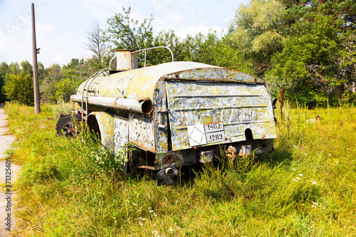 Radioactive dead zone of Chernobyl. Abandoned looted appliances, cars, electronics in Chernobyl accident. Consequences of evacuation, looting and vandalism after an explosion photo