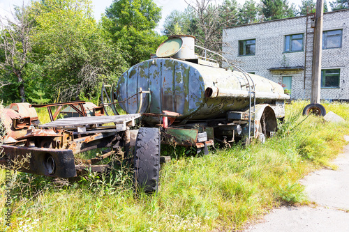 Radioactive dead zone of Chernobyl. Abandoned looted appliances, cars, electronics in Chernobyl accident. Consequences of evacuation, looting and vandalism after an explosion photo