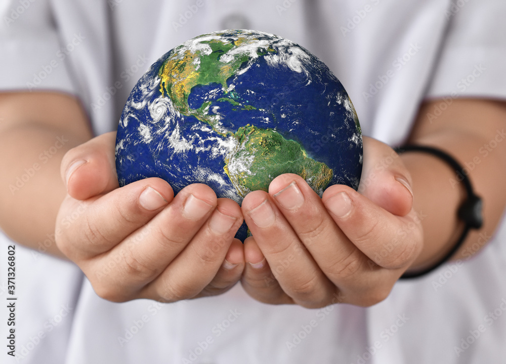 Environment day concept, Earth in child hands. Elements of this image furnished by NASA Environment day concept, Earth in child hands. Elements of this image furnished by NASA