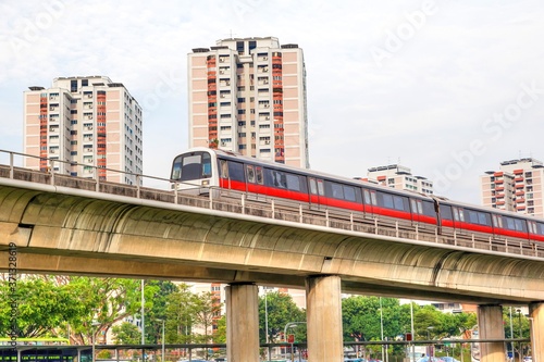 Photography Singapore subway train on elevated tracks through a public housing estate