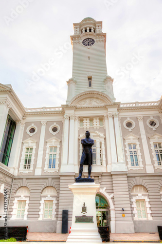 Victoria Theatre and Concert Hall is a colonial-style historic building in Singapore with the statue of founder Stamford Raffles in front.