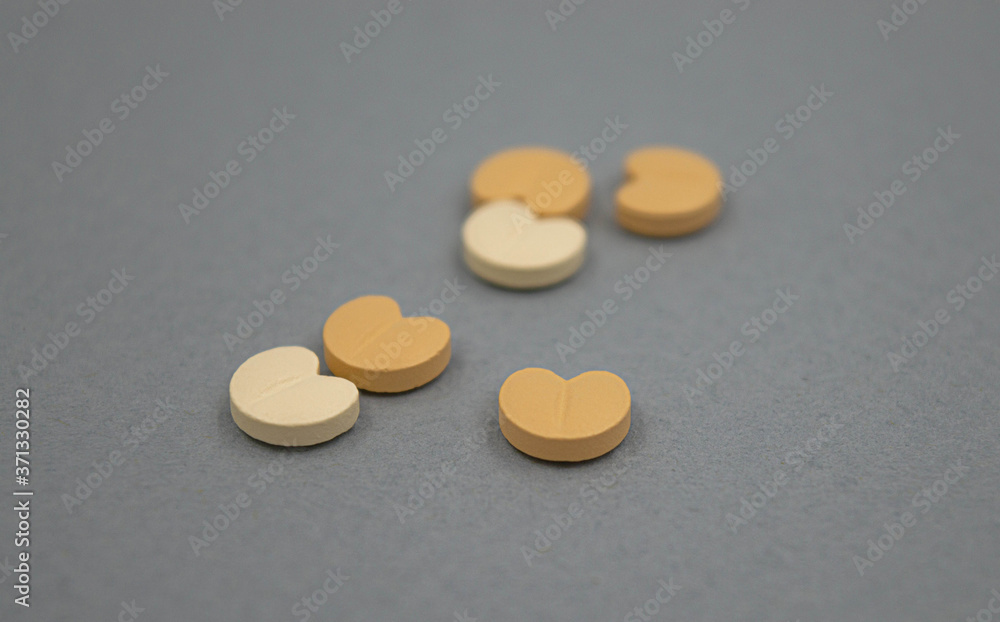 Heart pills on grey background Heart pills on grey background