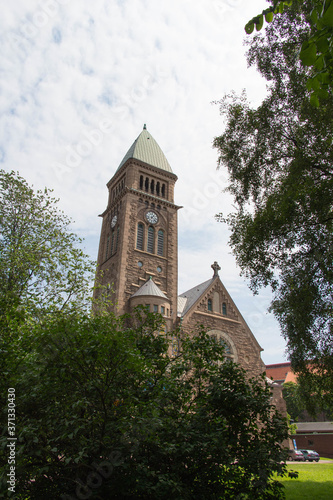 Gothenburg, Sweden - June 18 2019: the view of Vasa Church seeing from trees on June 18 2019 in Gothenburg, Sweden. photo