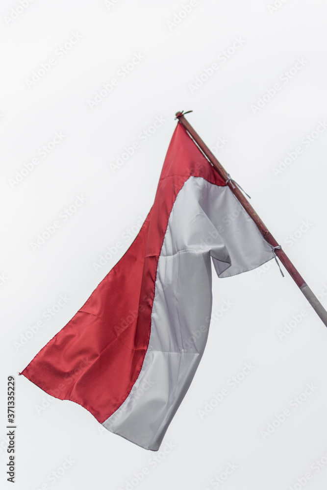 Indonesian flag waving with cloudy sky background Indonesian flag waving with cloudy sky background