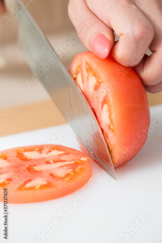 トマトを切る女性の手元