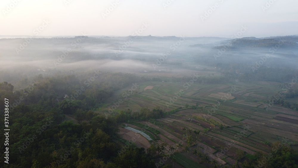 Aerial view of sunrise with light mist. Mount Ireng Gunungkidul Yogyakarta