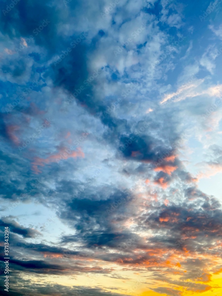 Blue sky with white clouds at sunset in summer time.Free space. Blue sky with white clouds at sunset in summer time.Free space.