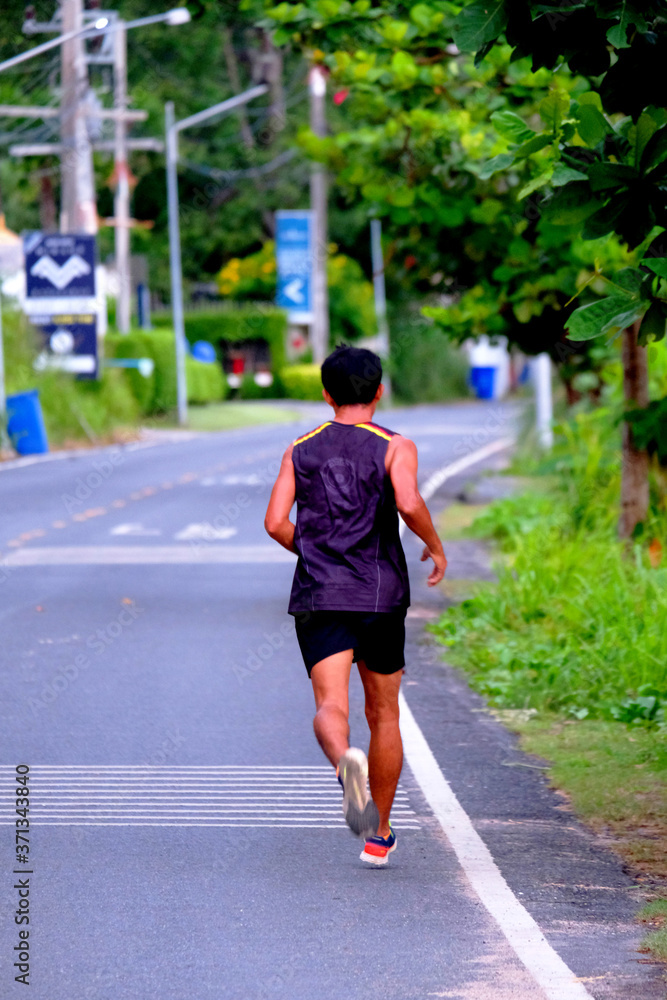 A runner warms up on road in early morning  along the seaside
