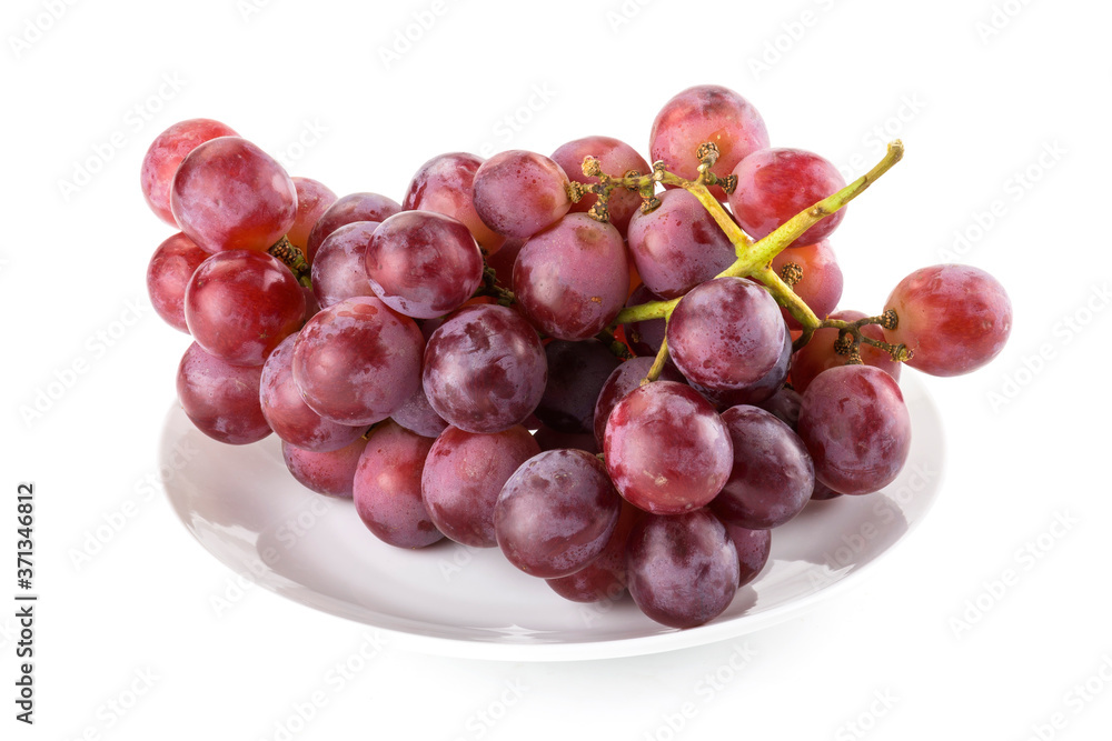 Close-up red ripe grape on the white dish, it is a sweet and juicy fruit. Close-up red ripe grape on the white dish, it is a sweet and juicy fruit.